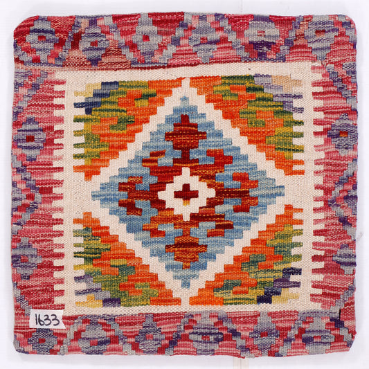 Front of diamond kilim cushion cover with red border and multicolor geometric motif