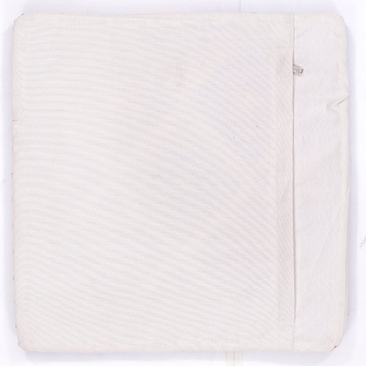 White kilim cushion cover with subtle texture and seam detail