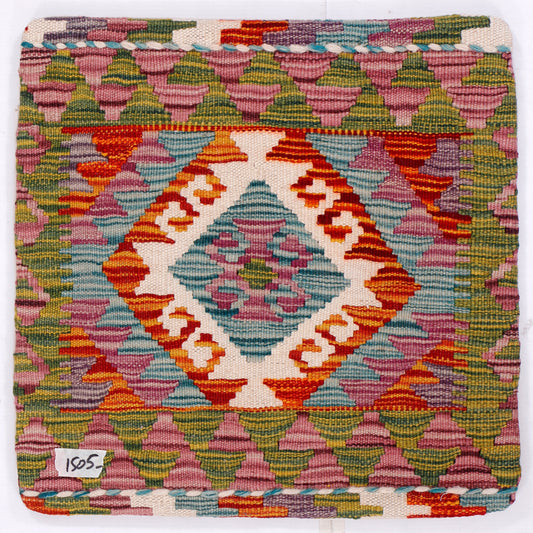 Kilim cushion cover close-up: central diamond medallion in blue, orange, green, and pink