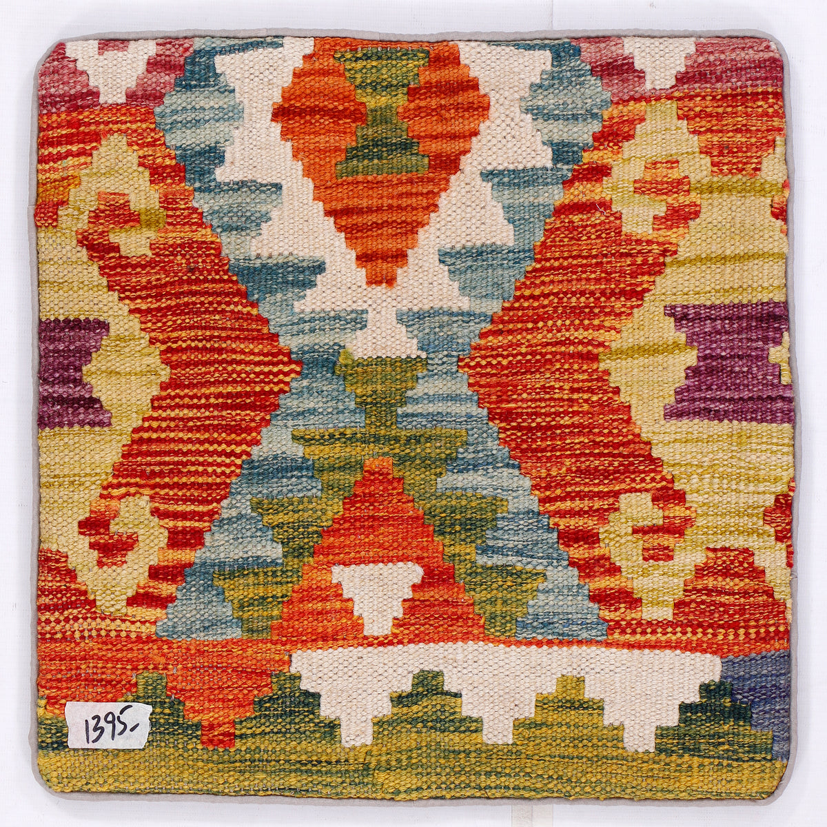 Kilim cushion cover with orange, blue, and green geometric pattern front