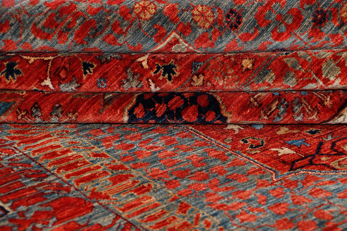 Woven texture view of red and blue traditional rug with dense geometric pattern