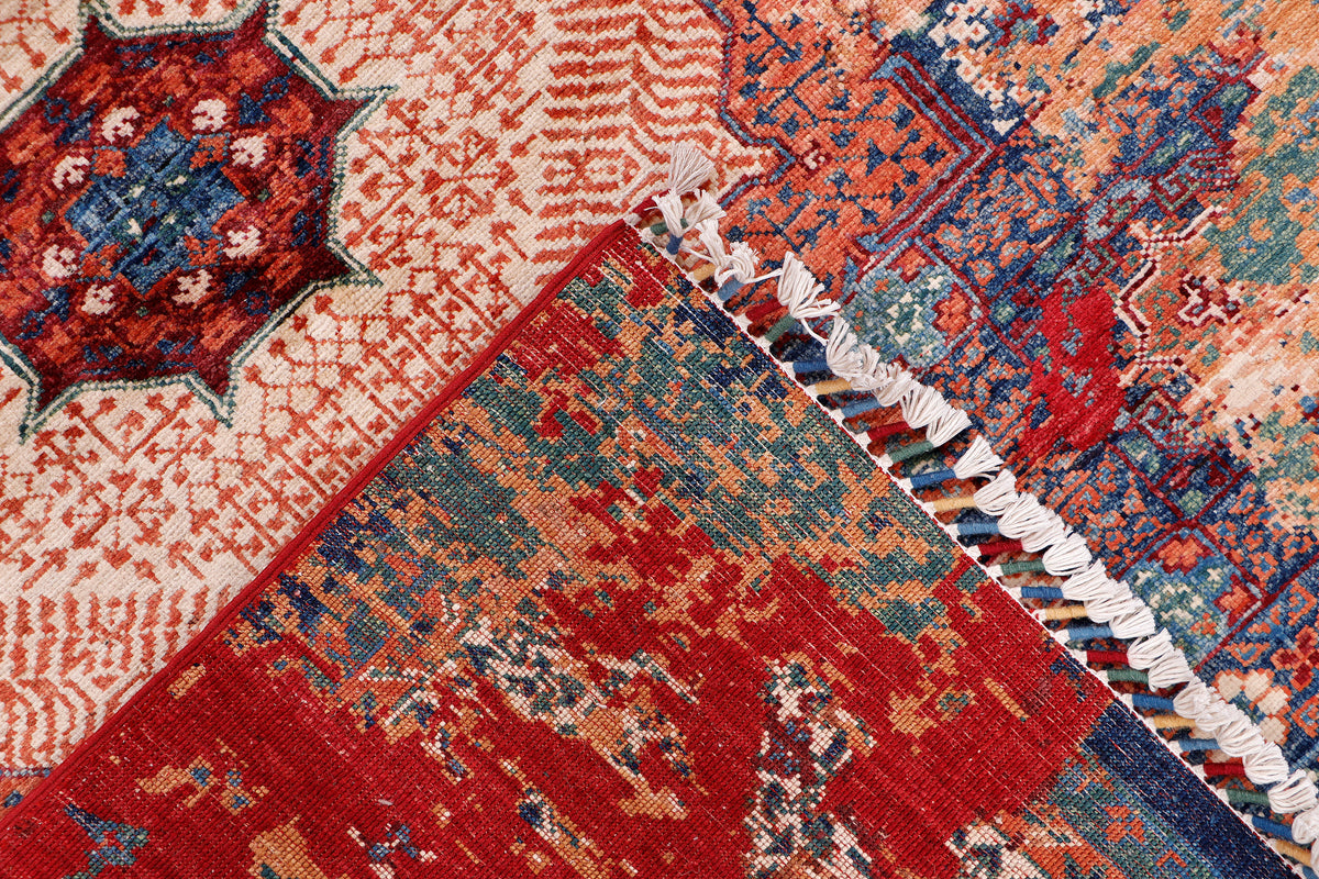 Kilim rug detail with red and blue diamond motifs and cream ground, fringe edge