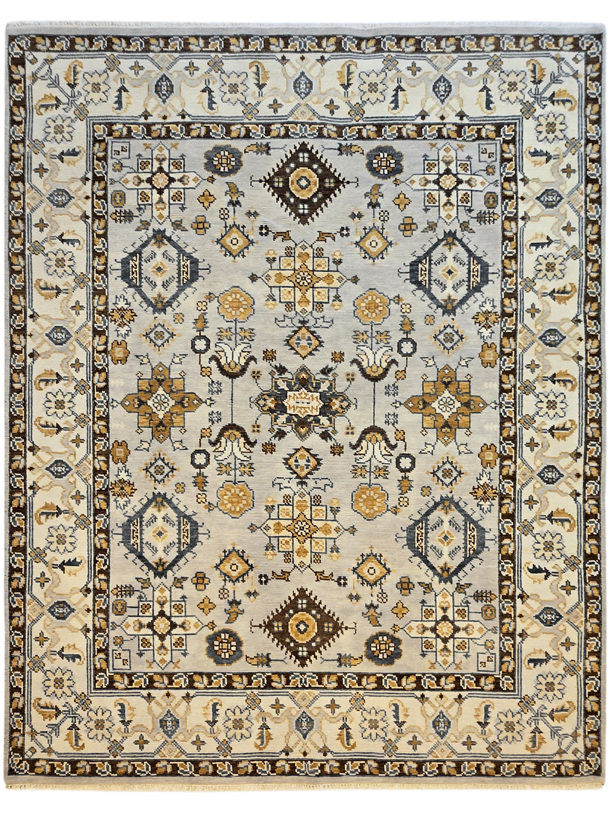 Square Oushak rug with ivory field, navy and gold medallion, symmetrical geometric border design.