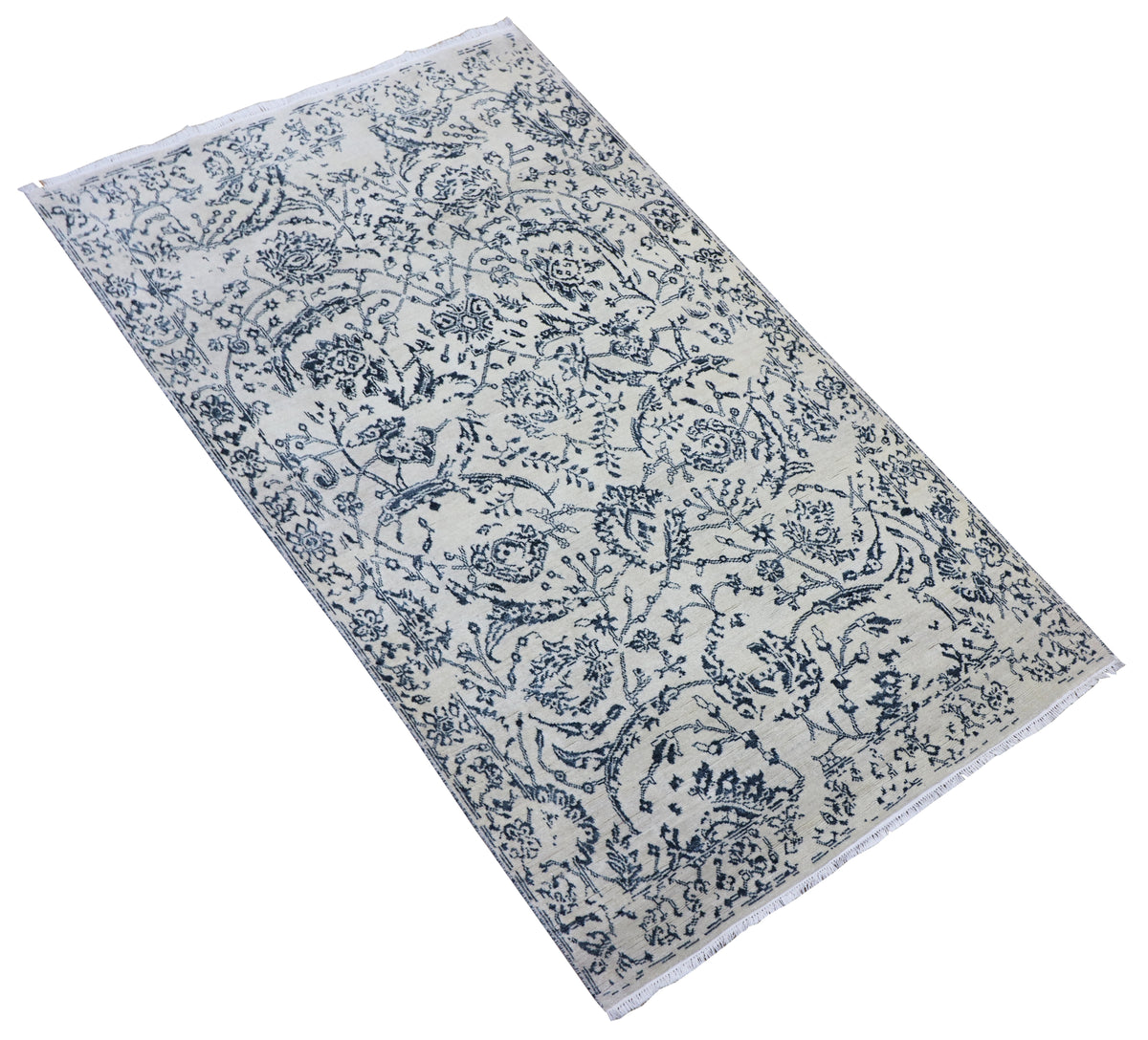 Delft blue and off-white vintage-style area rug with floral scroll pattern