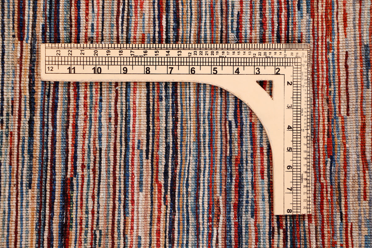 Striped area rug with measuring ruler across multicolor brown, red, blue, and cream