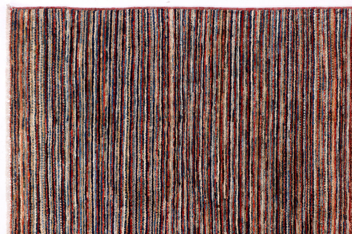 Striped Ziegler area rug with dark brown base and thin multicolor vertical lines