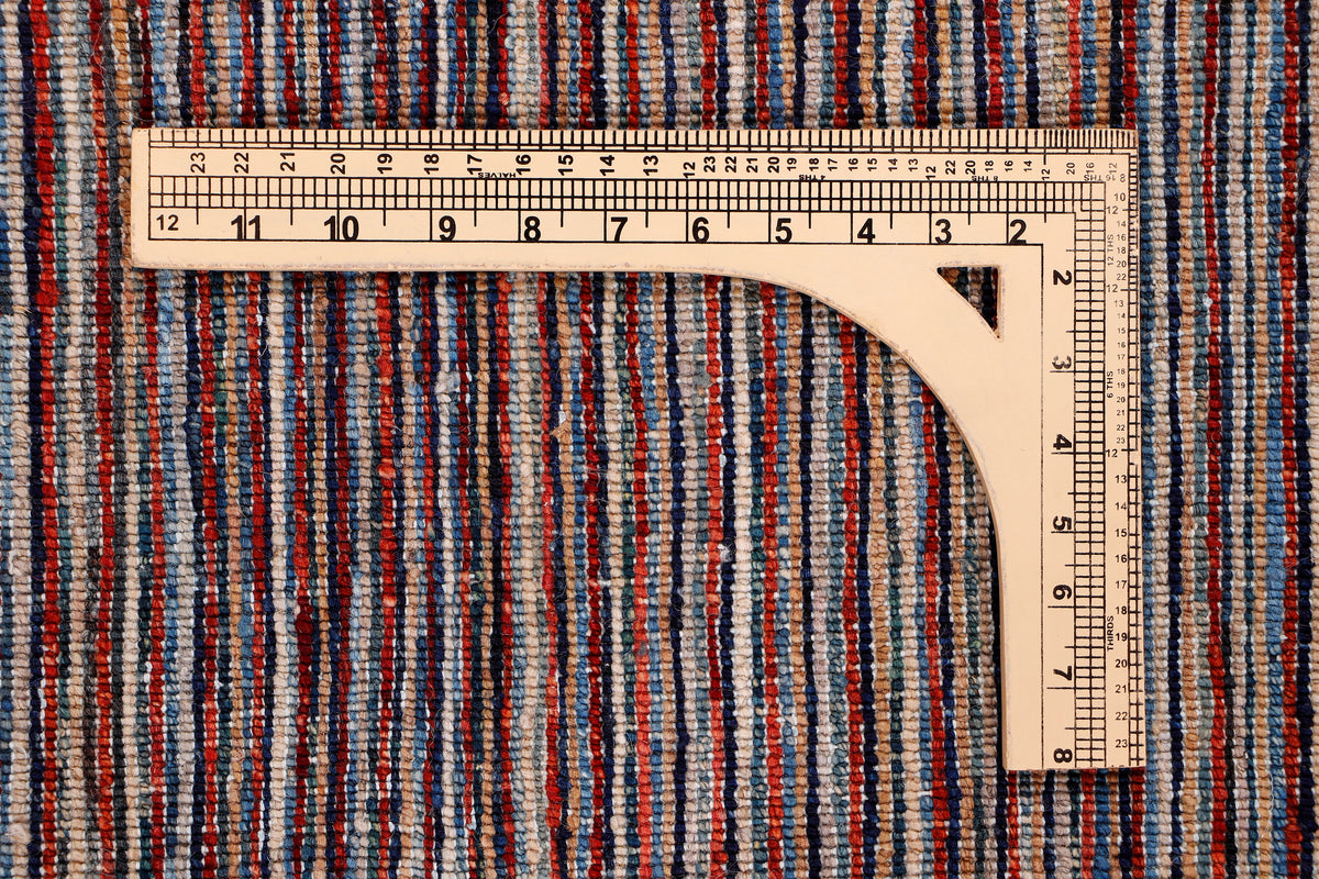 Striped area rug with dark brown base; measuring tape across the edge for size