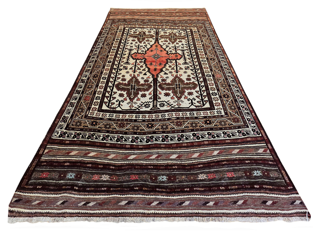 Soumak rug runner with red medallion, cream and black details, and striped ornamental border