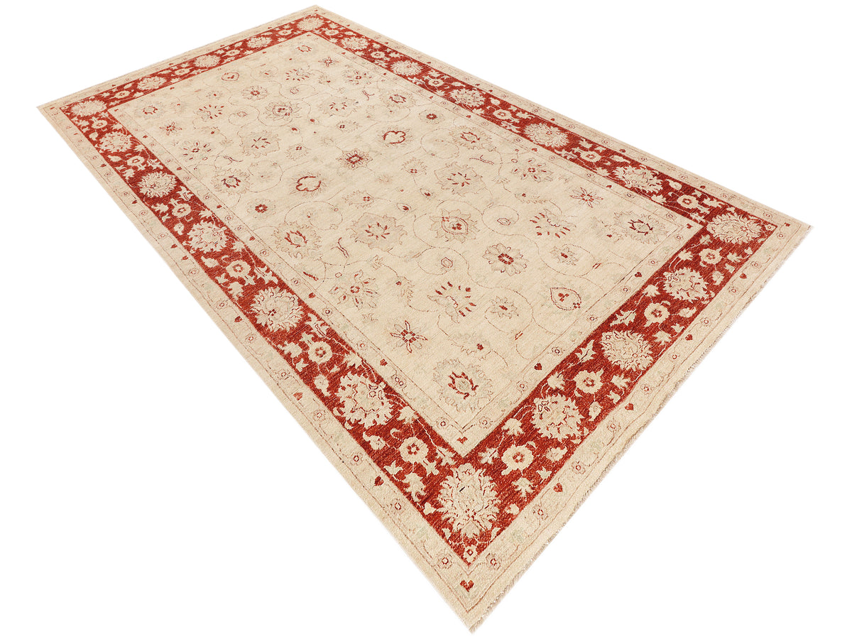 Ziegler Afghan rug angled view, cream field with red border and scattered motifs