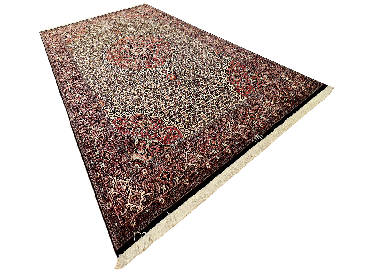 Bidjar rug angled with central medallion, red motifs, and cream fringe