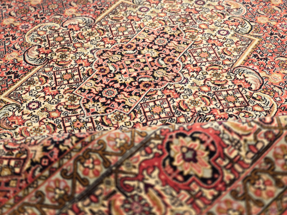 Bidjar rug pattern close-up with rust red, cream, and dark geometric motif details.