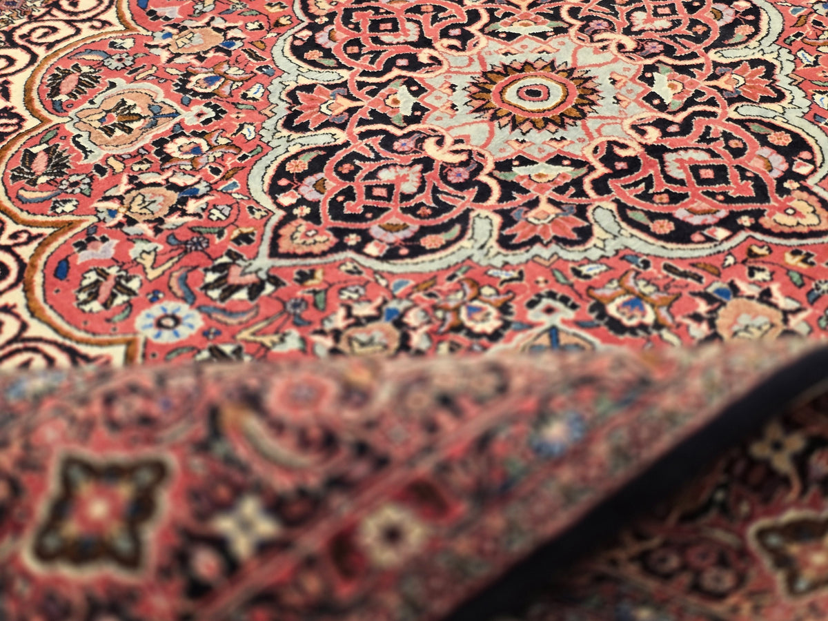 Bidjar rug close-up with red, cream, and dark floral motifs