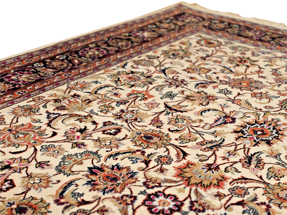 Close-up of cream floral rug field with multicolor vine and rosette motifs