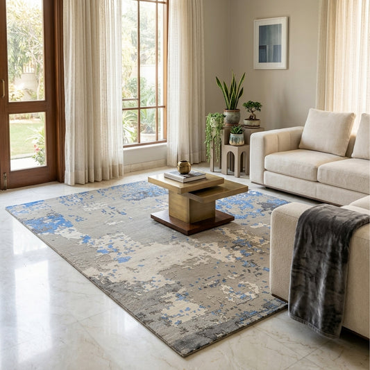 Abstract rug on floor with gray and blue distressed pattern, living room view