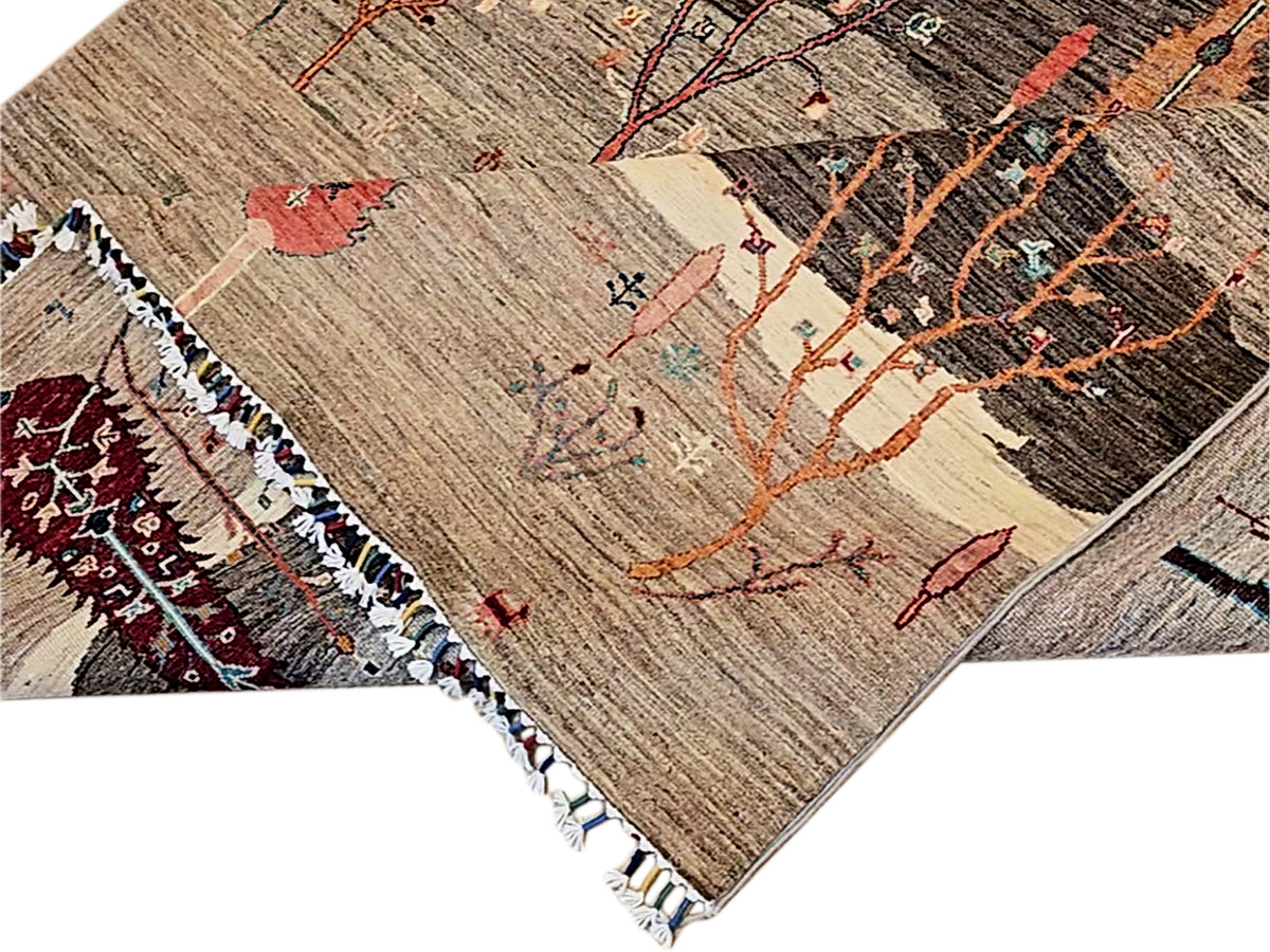 Rug corner detail with tree branches, brown and cream ground, red medallions, tasseled fringe