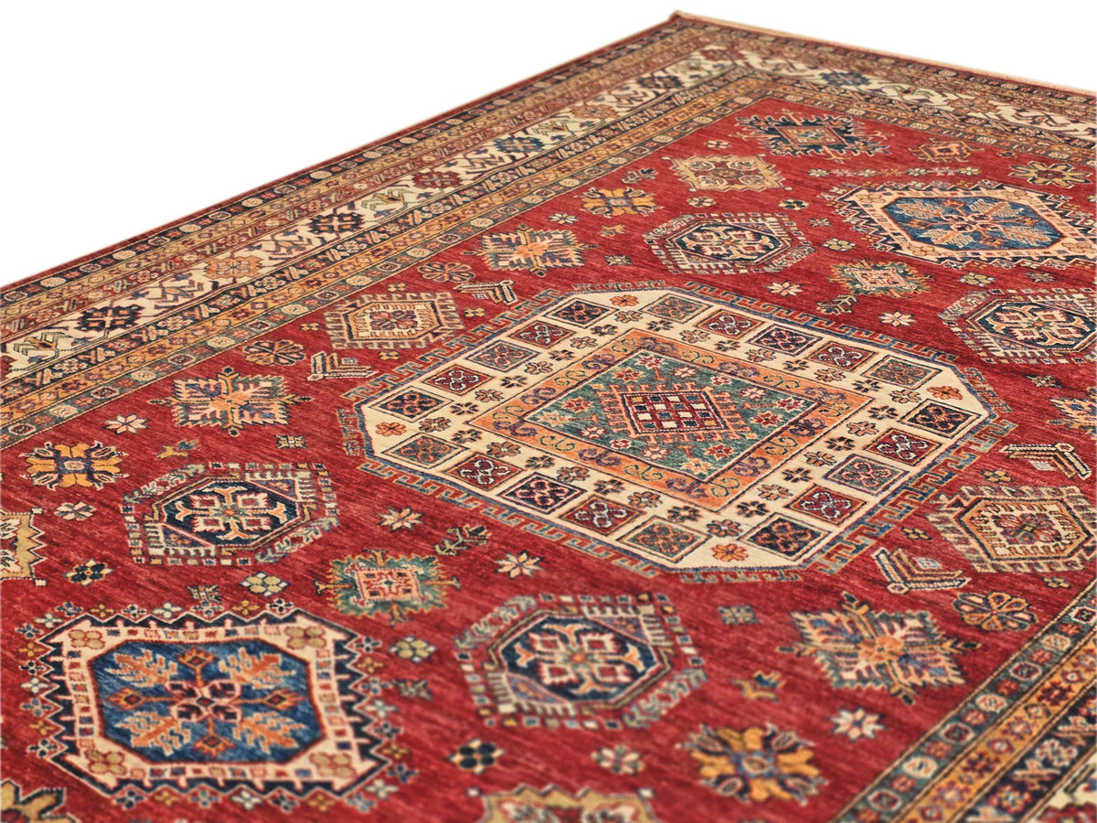 Kazak rug, 289x201 cm, red field with geometric medallions and ornate border