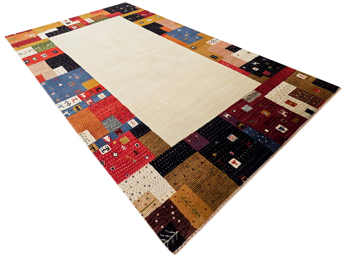 Rectangular patchwork area rug with cream center and multicolor geometric frame