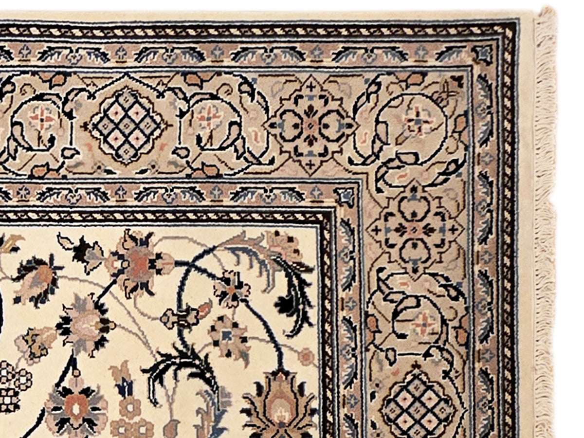 Nain rug pattern close-up with cream background, navy medallions, and decorative corner border