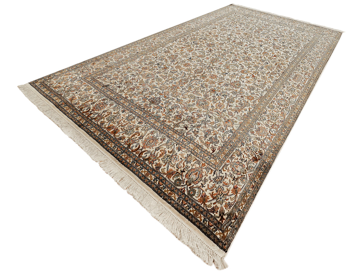 Beige patterned silk rug with all-over floral design and dark border lines