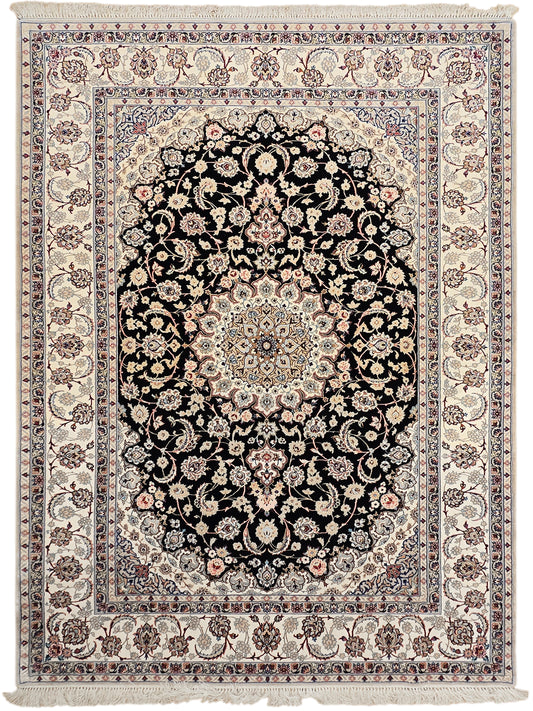 Isfahan rug front view: black floral medallion on cream with detailed blue border and fringe