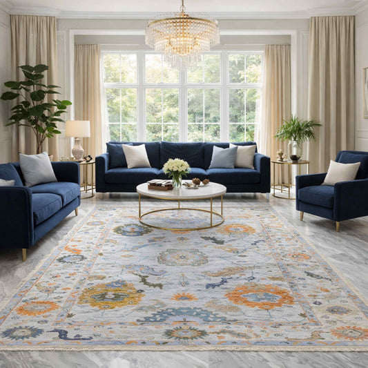 Oushak-style area rug in light blue with medallions and orange accents, ornate border