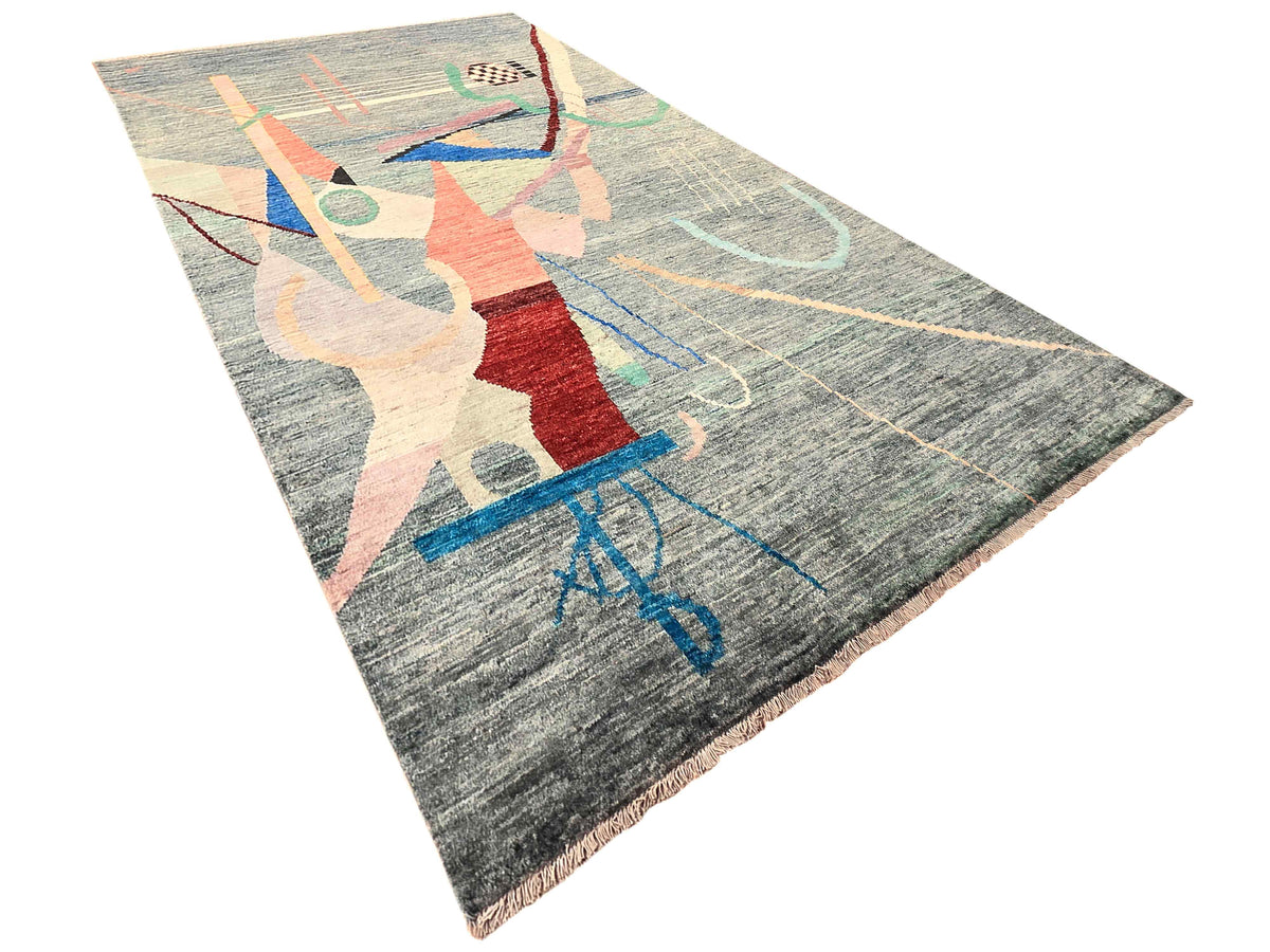 Abstract geometric area rug with red, beige, and blue accents on gray pile