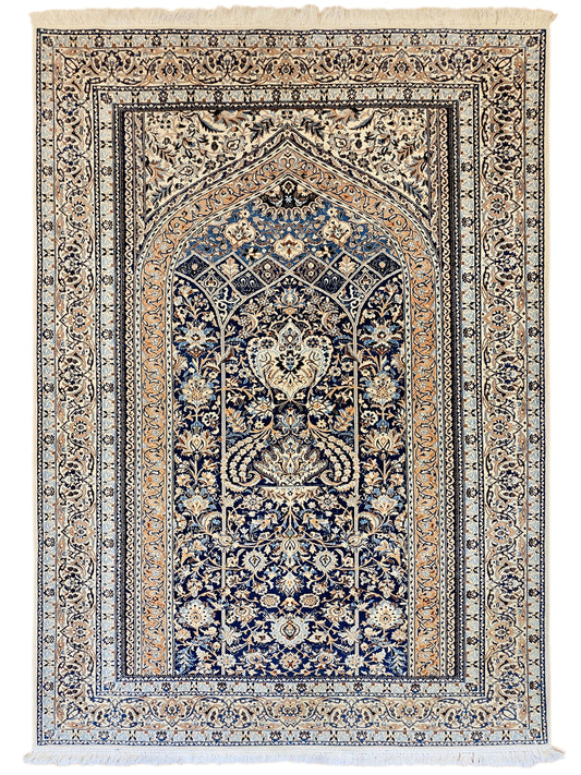 Blue and cream medallion area rug with detailed motifs and fringed edges