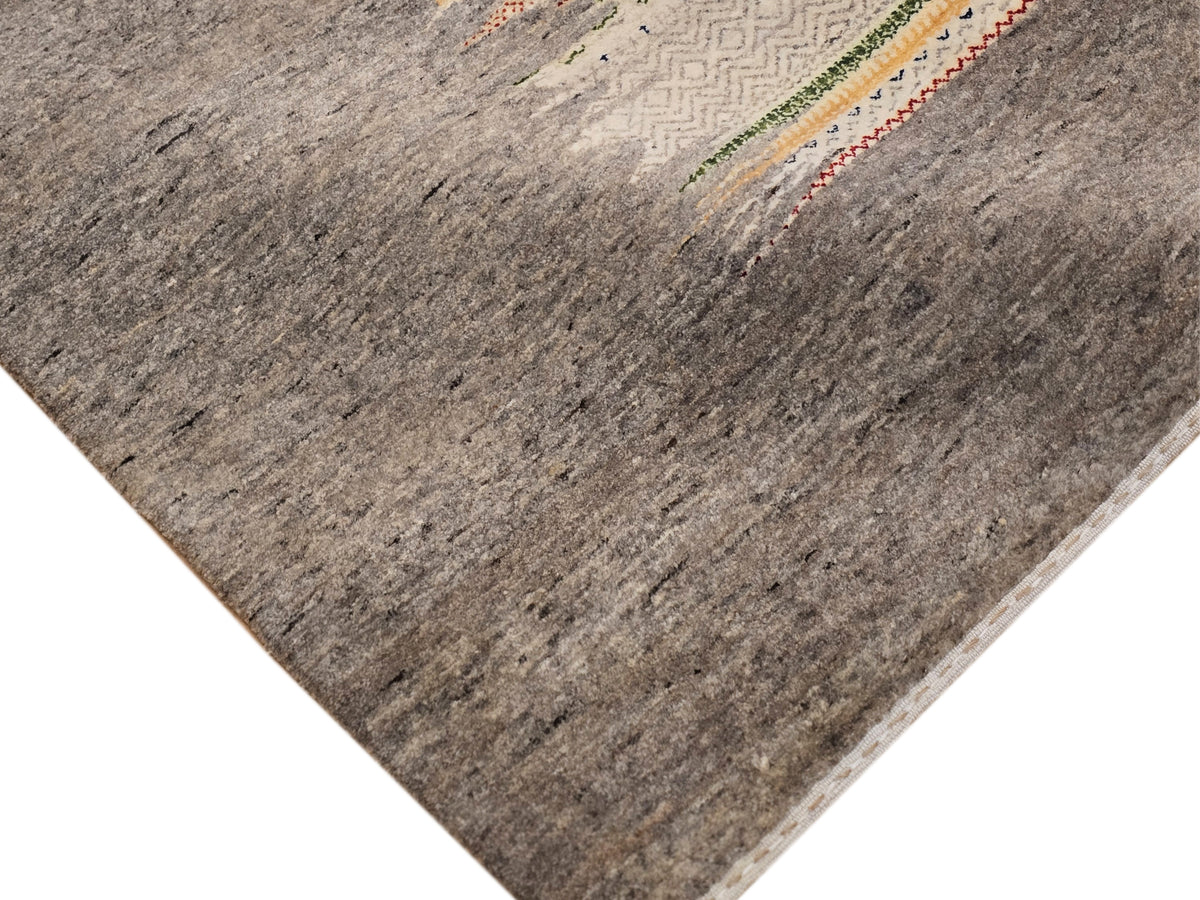 Grey Loribaft rug corner detail with faded horizontal lines and small stripe motifs