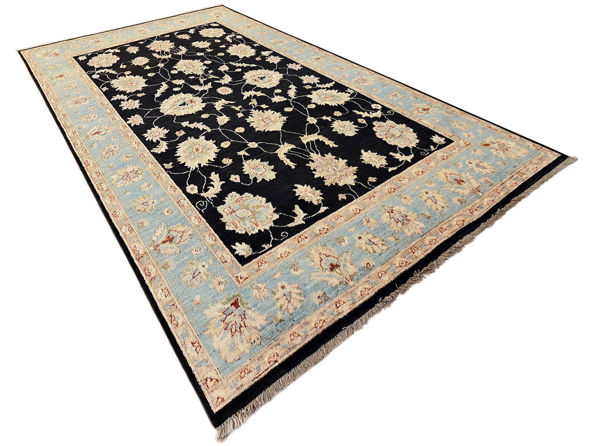 Black floral rug with light blue border and cream blossoms, ornate center medallion