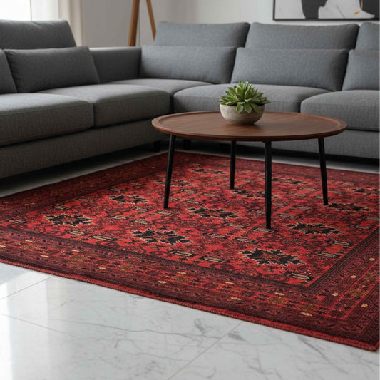 Red patterned area rug with geometric designs and fringed border