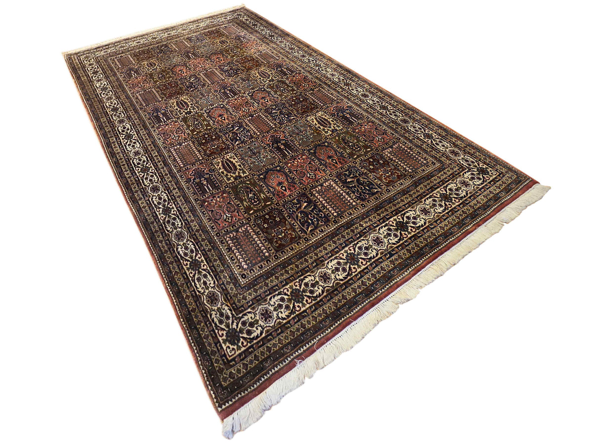 Multicolor Qum-style rug with central medallion pattern and cream fringe edges