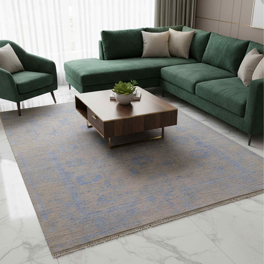 Blue abstract rug with fringe, styled on a marble floor in a living room