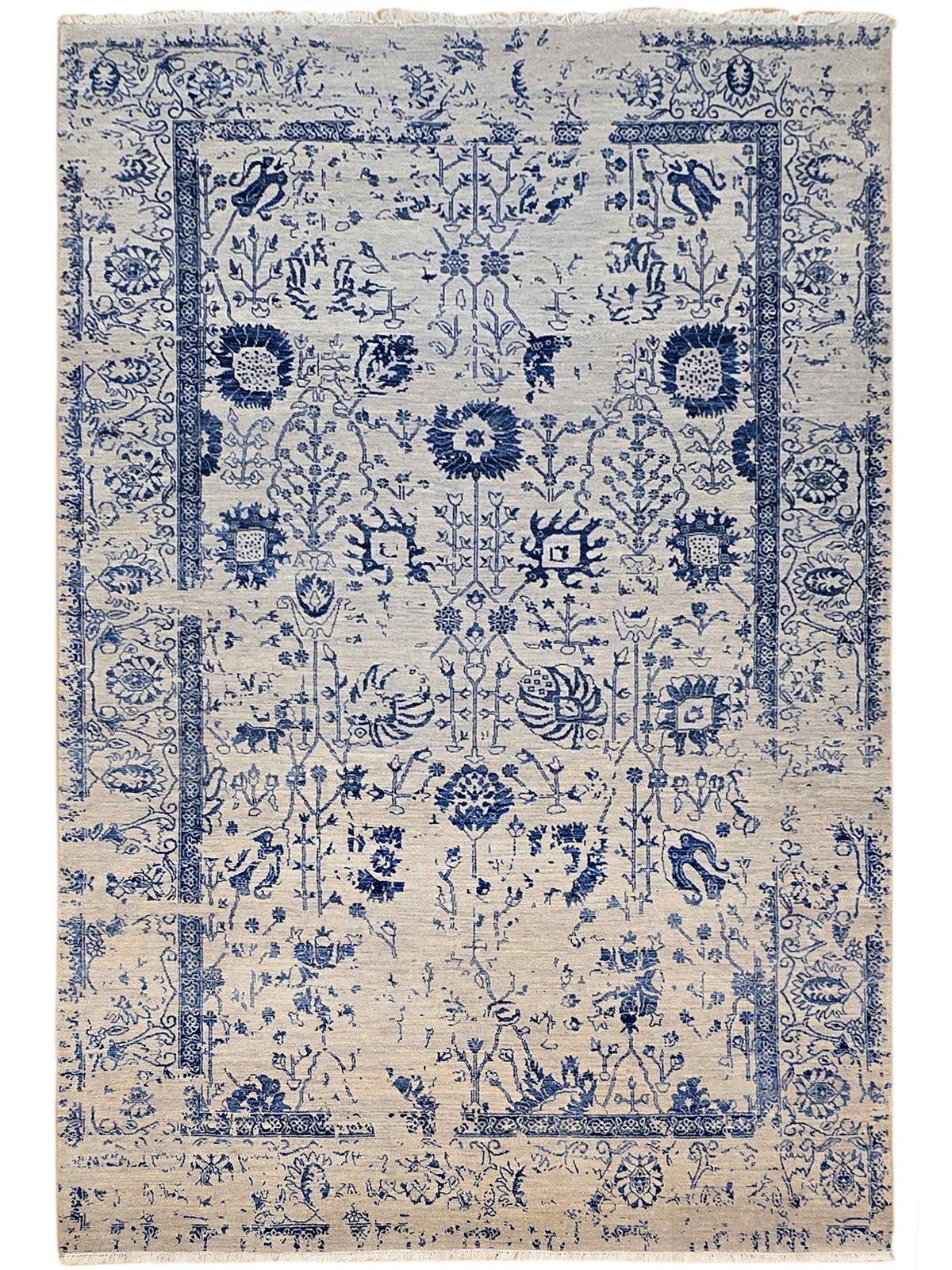 Beige and blue patterned area rug with symmetrical medallion motifs and border, flat lay.