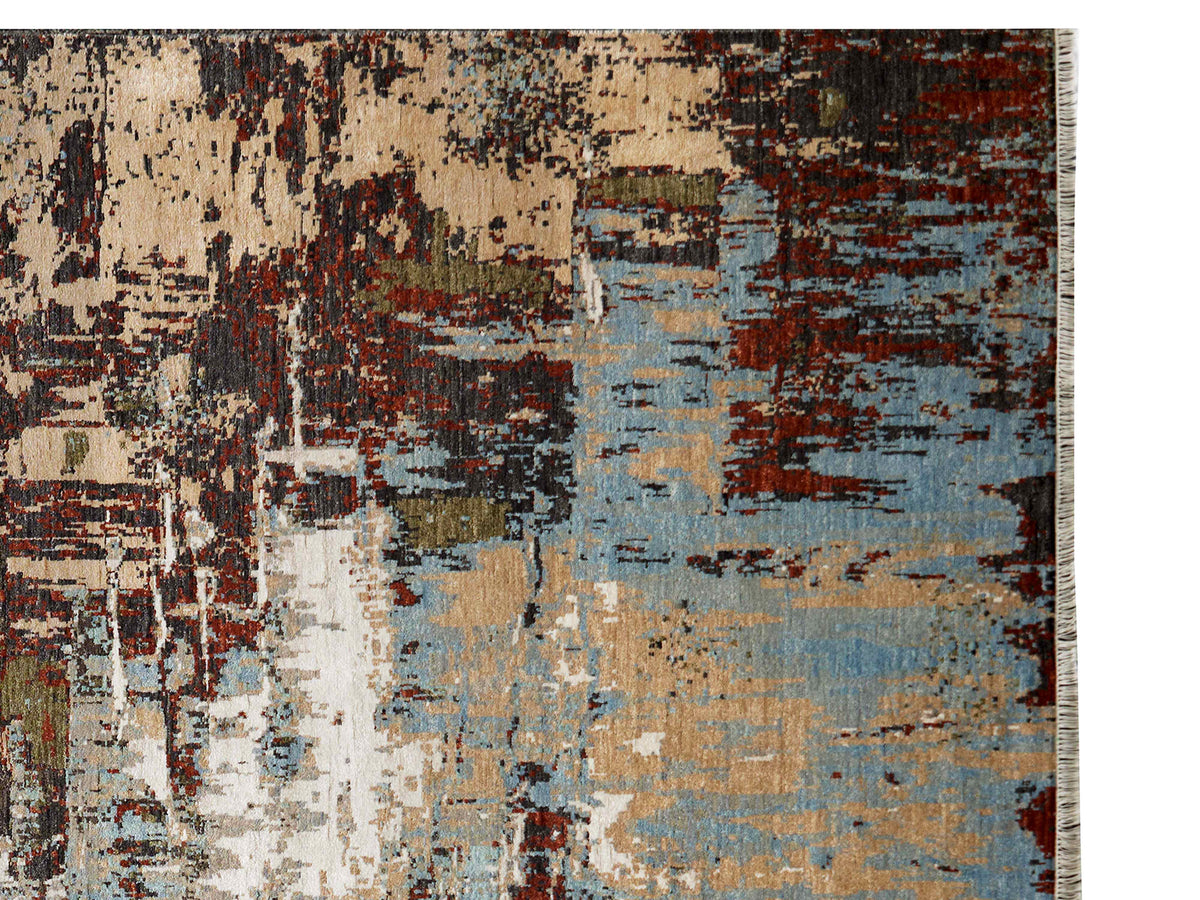 Close-up of abstract rug texture with beige, blue and rust mosaic distressing.