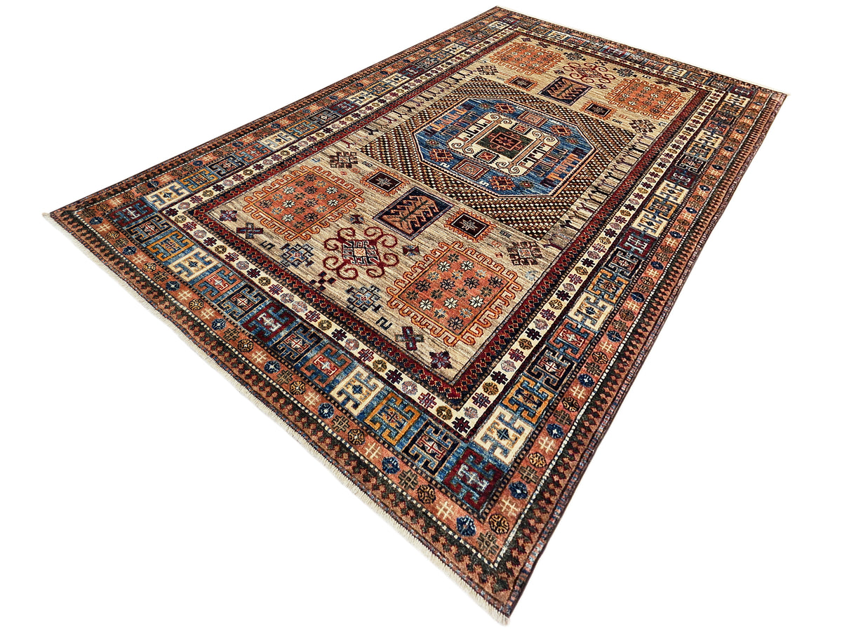 Kazak-style rug diagonal view with medallion panels and ornate geometric border, rust and blue