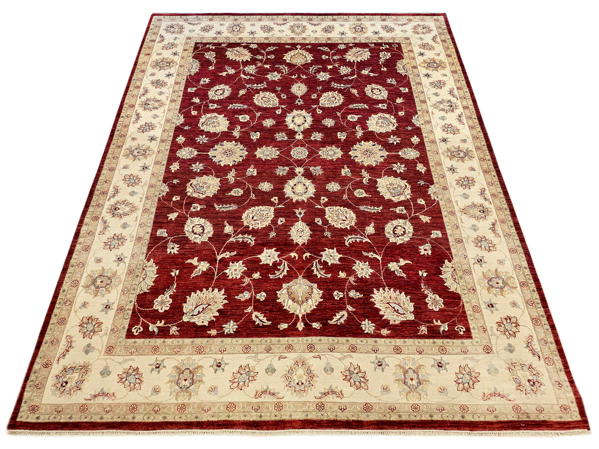 Ornate floral area rug with burgundy red center, cream border, and decorative medallions