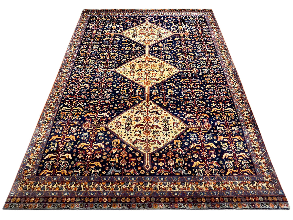 Dark navy rug with large cream diamond medallion, symmetrical floral ornaments