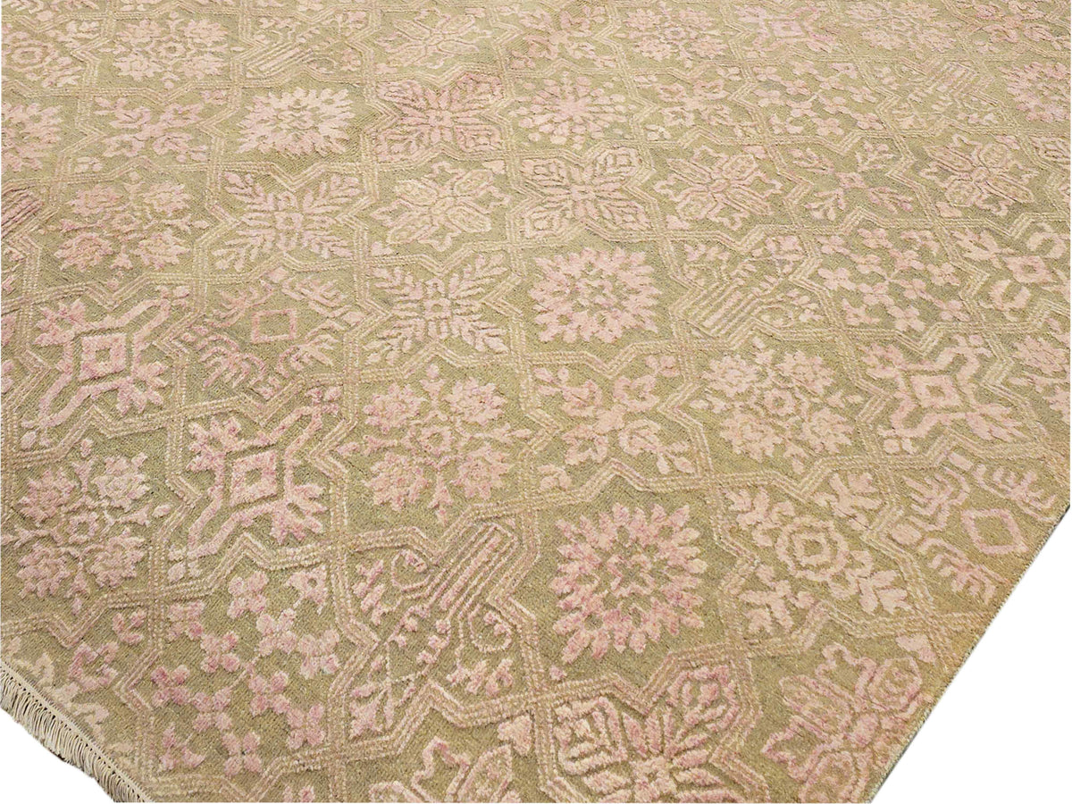 Close-up of beige rug with intricate cream and pink geometric floral pattern