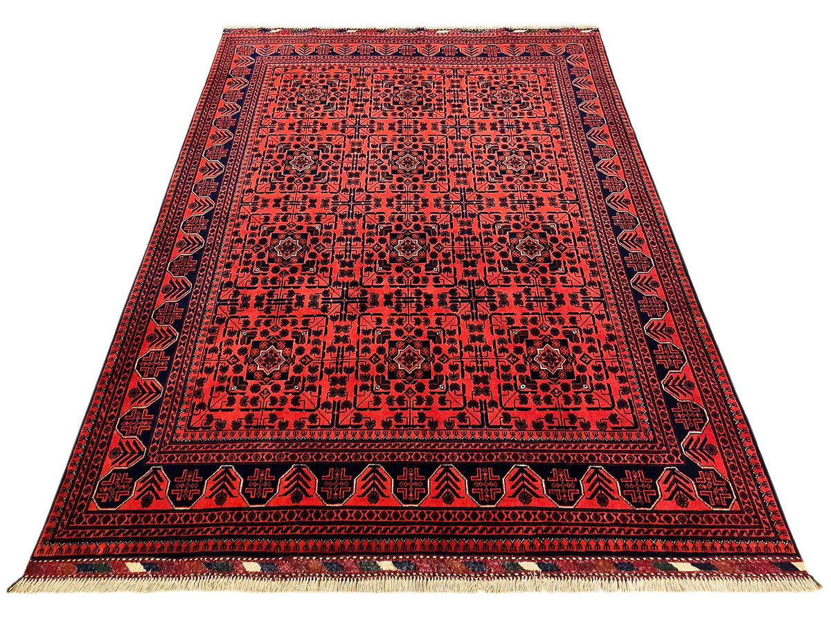 Red rug with symmetrical navy border and beige fringed trim