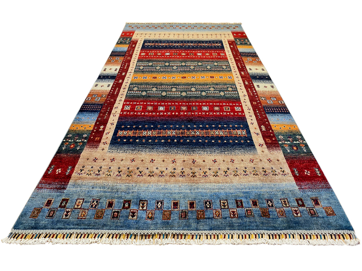Triangular view of multicolor geometric rug with wide border and fringed hem.
