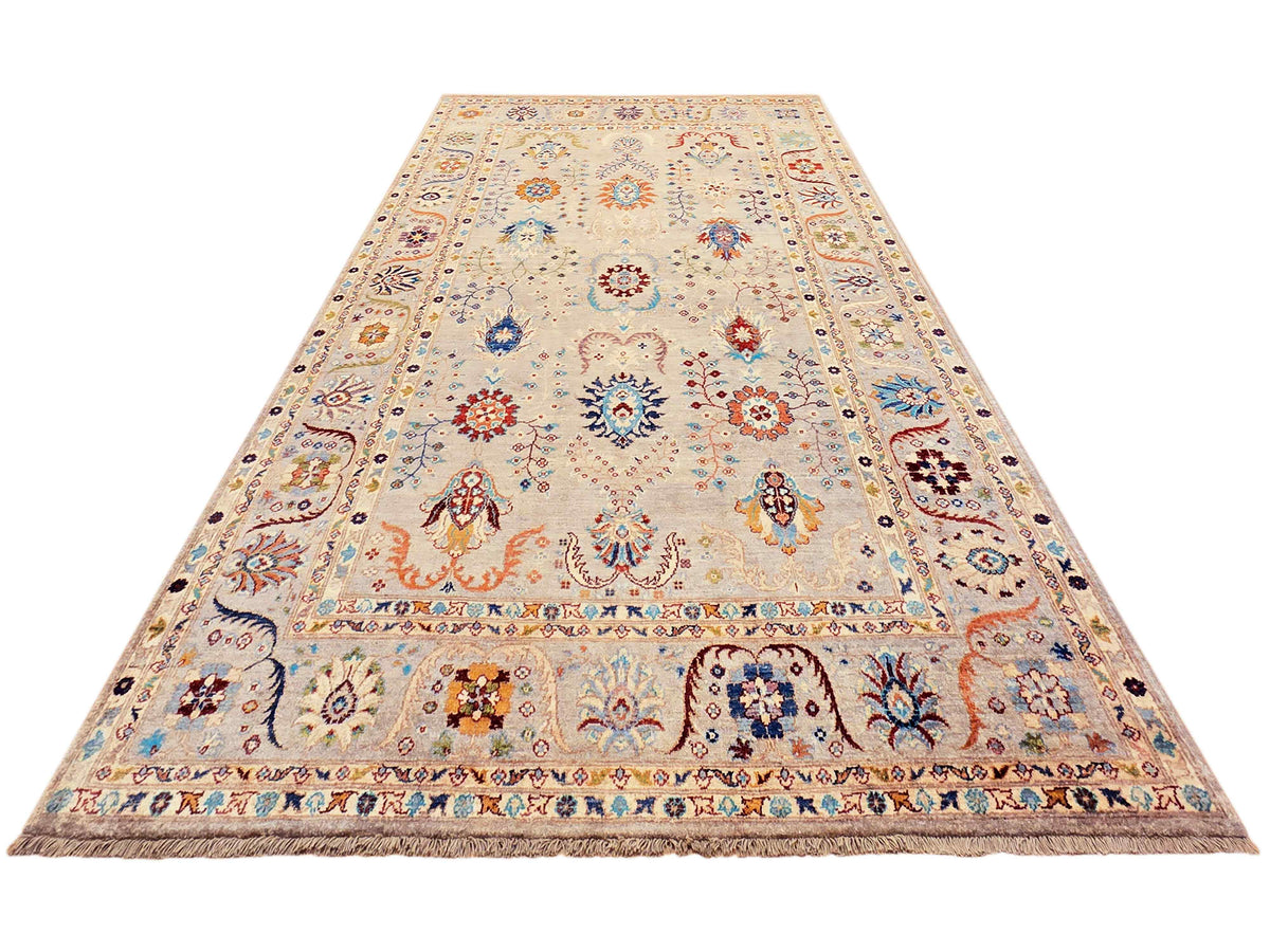 Light beige area rug with repeating medallions, multicolor accents, and detailed border trim