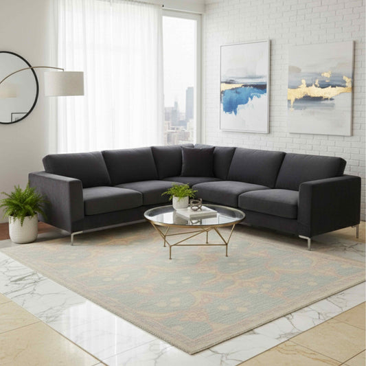 Light blue-gray patterned rug with coral medallion design on floor, in living room