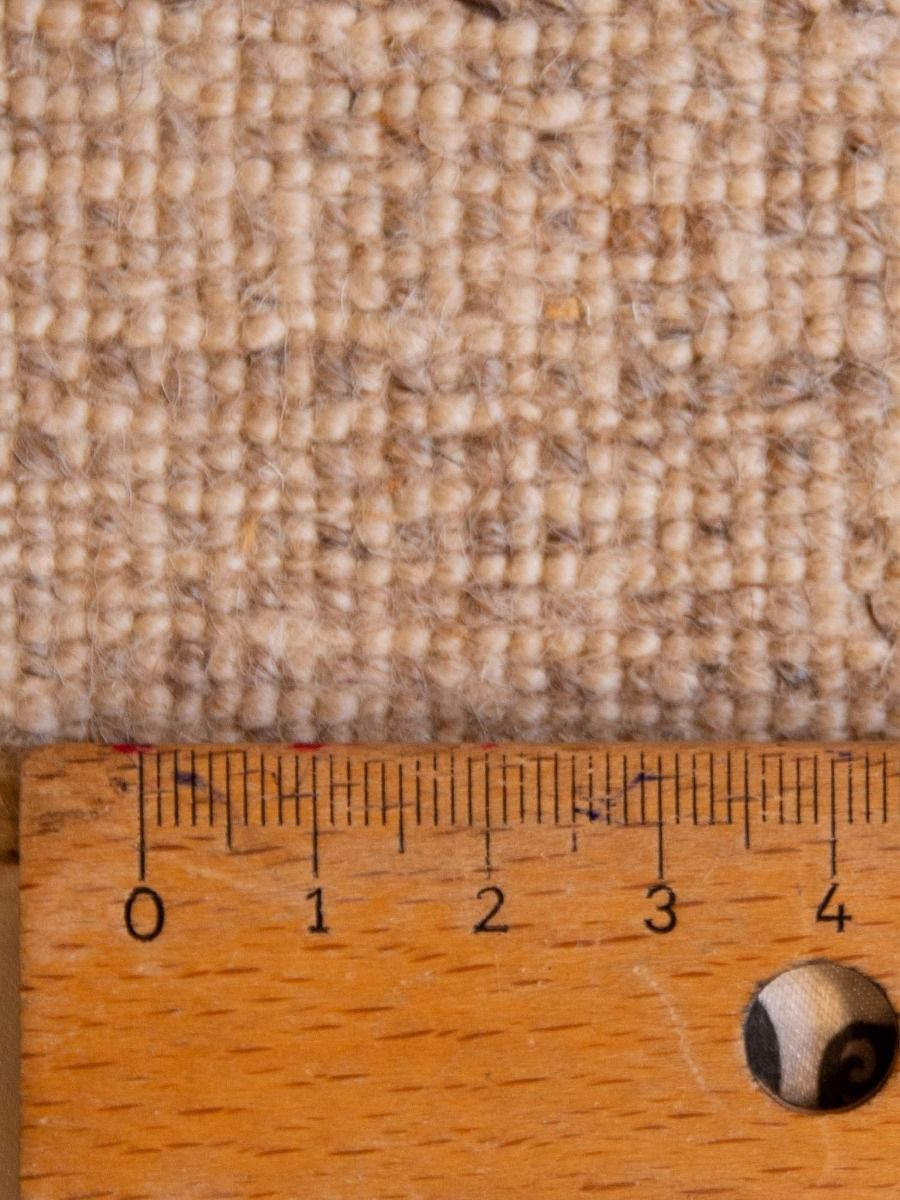 Beige rug texture close-up with ruler scale and corner detail
