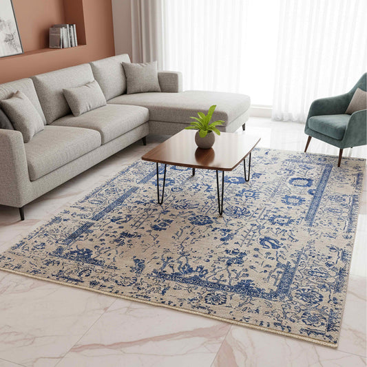 Blue and cream patterned area rug with border and short fringes on floor