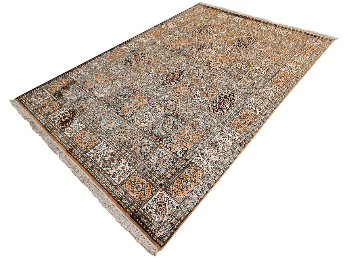Silk rug with corner detail, intricate medallions and scrolling floral patterns.
