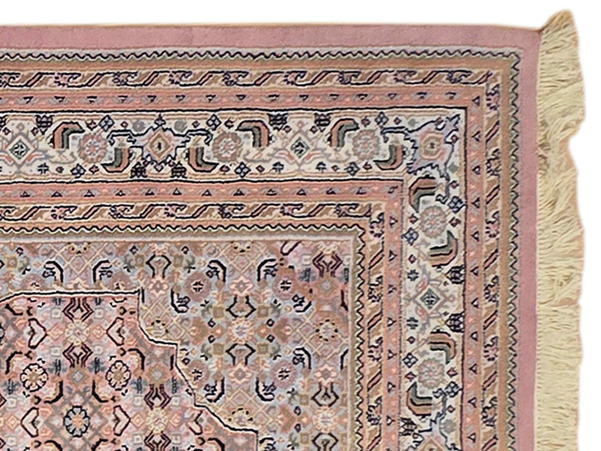Bidjar rug border close-up with cream paneling, navy accents, and cream fringe edge