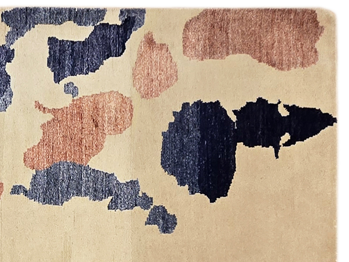 Beige area rug with bold blue and rust abstract blocks