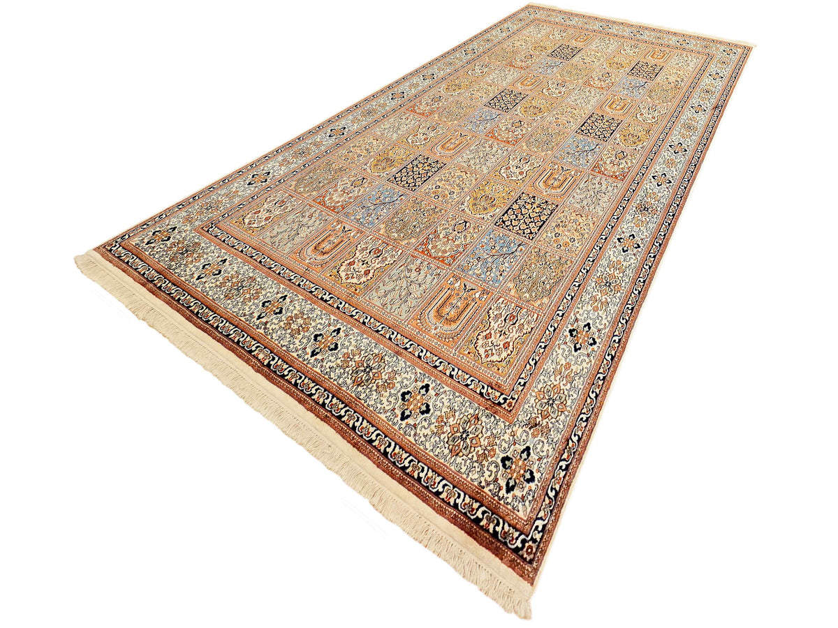 Diagonal view of a patterned rug with bordered field and cream fringes