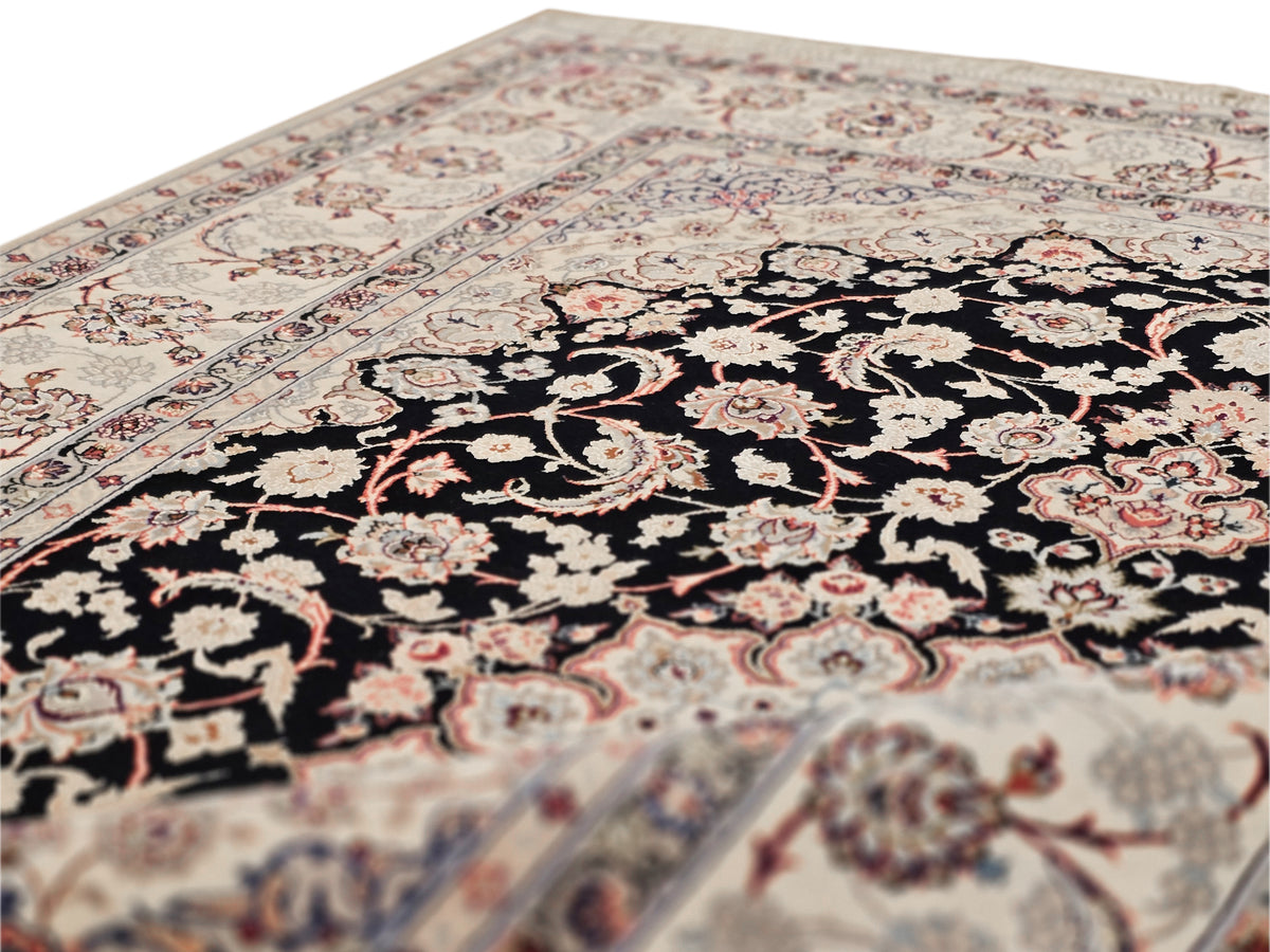 Isfahan rug: black floral medallion on cream, ornate border with short fringes