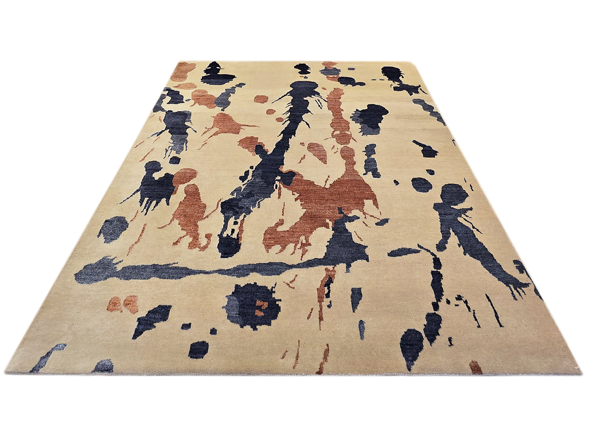 Rectangular beige rug with dense blue and rust abstract splatter pattern
